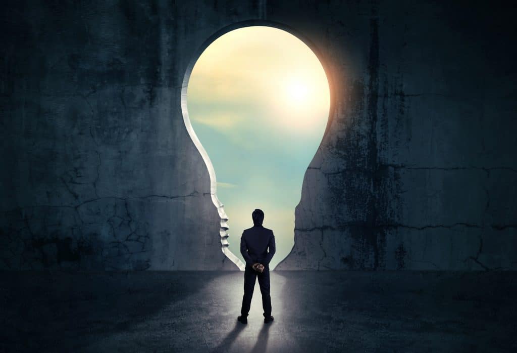 businessman-looking-out-abstract-opening-wall