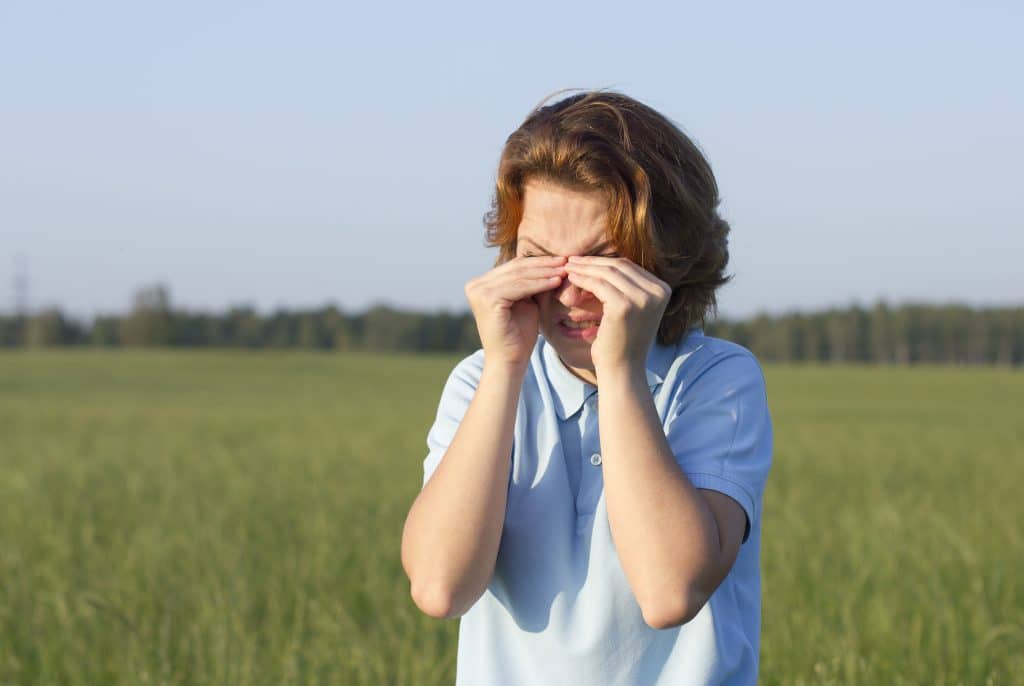 young-woman-suffering-from-itching-girl-is-scratching-eyes-outdoors-summer-park-disgusted-woman-rubbing-her-eyes-eyes-are-tired-watery-female-is-crying