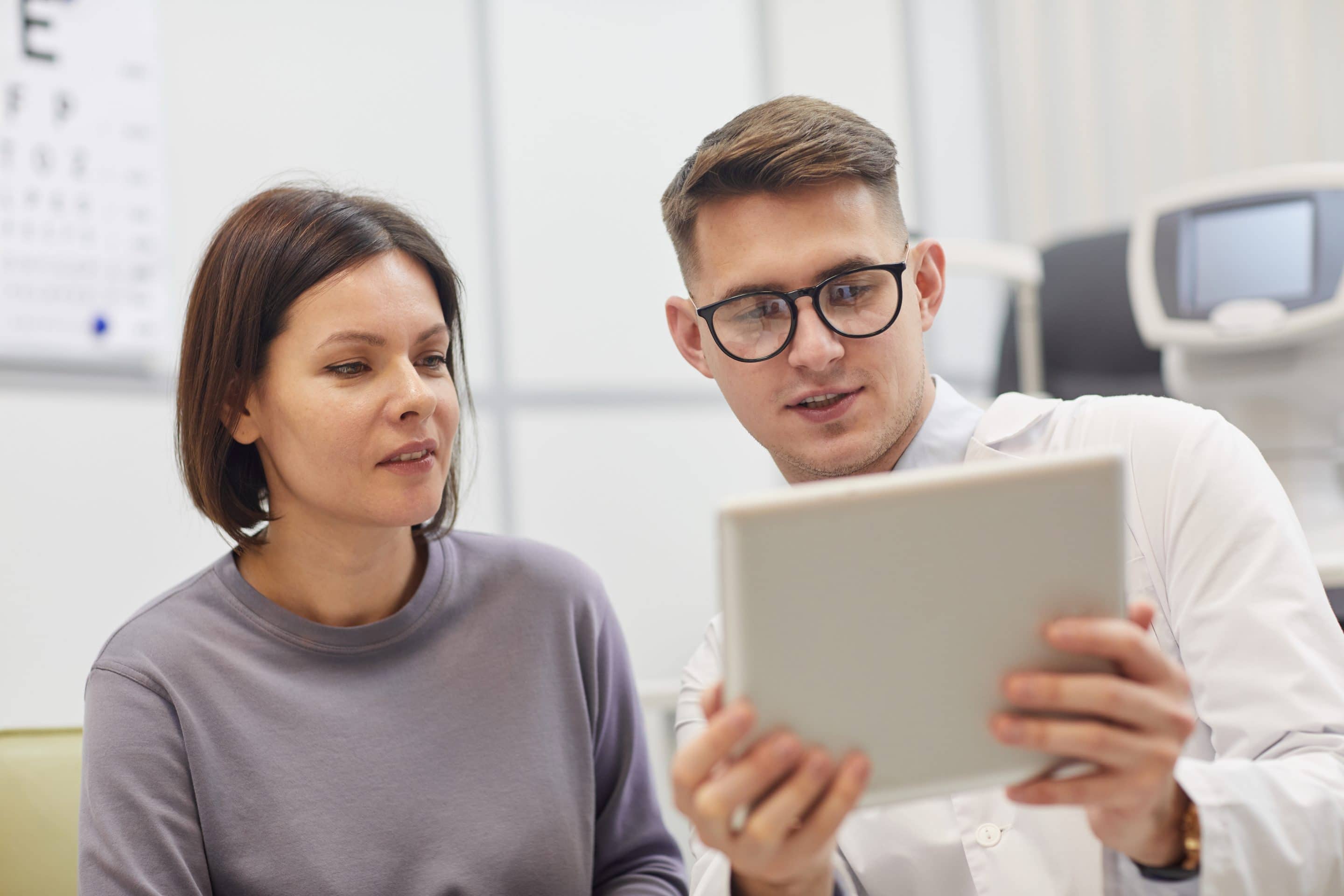 Ophthalmologist Consulting Woman in Clinic